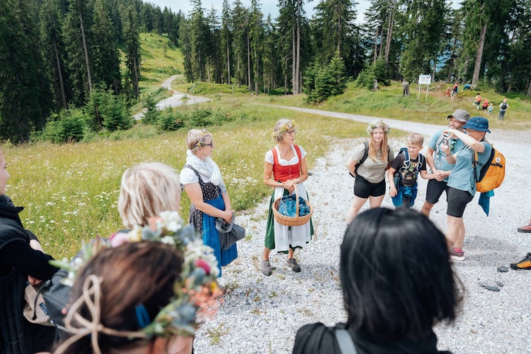 Eine Frau leitet eine Gruppe bei einer Kräuterwanderung am Hochkönig.