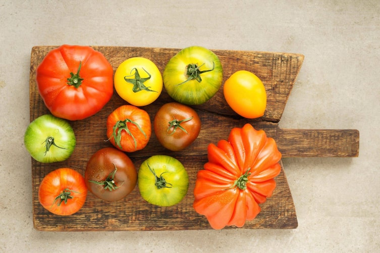 Gelbe, rote, grüne Tomatensorten auf einem Holzbrett