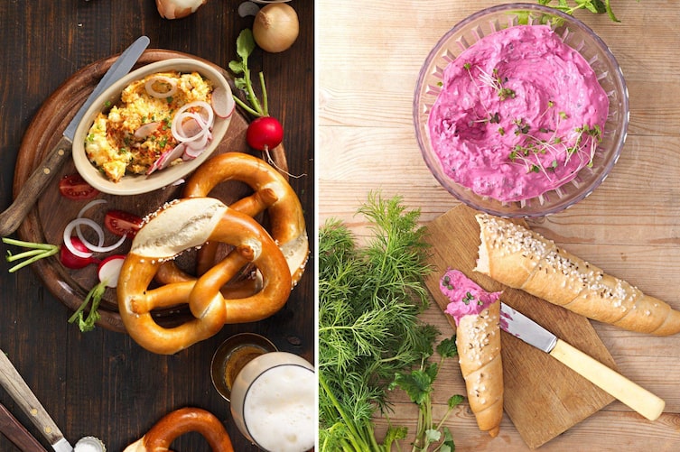 Obazda mit Laugenbrezen, Bier, Radieschen auf einem Holzbrett. Roter Rüben Aufstrich in einer kleinen Glasschüssel, daneben liegt ein Bund Dille, ein Jausenbrett mit Salzstangerl und Buttermesser.