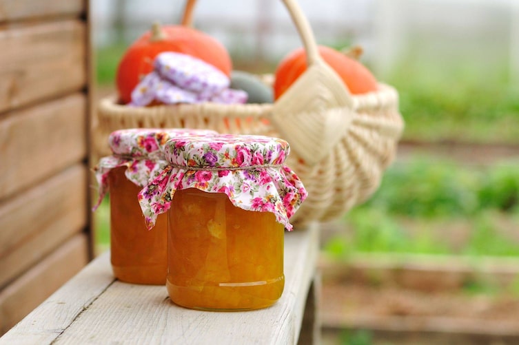 Kürbis-rezepte, einkochen, einlegen, haltbar machen, ein Korb mit Kürbissen, im Vordergrund ein Glas Kürbis-Marmelade