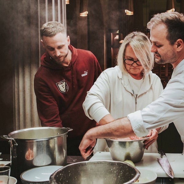 Marko Arnautović, Mama Gabriela von Marko Arnautović, Starkoch Fritz Grampelhuber kochen gemeinsam Faschierte Laibchen. Sie stehen in der Küche und rühren gerade die Masse dafür an.