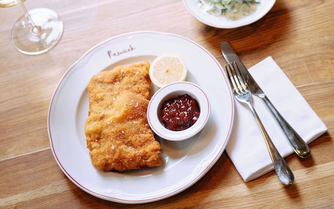 Cordon bleu aus dem Wirtshaus Reznicek in Wien mit Preiselbeermarmelade und Gurkensalat.