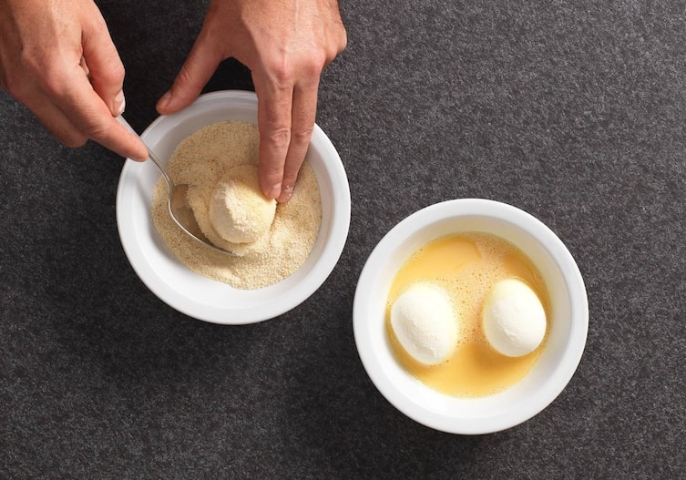 Eier, Semmelbrösel, Löffel, Hände, Schüssel