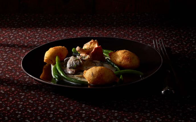 Knusprige Erdäpfelnockerl mit Butterfisolen und Schwammerlragout, Schnittlauch, Schalotten, Teller, Gabel, Tischtuch