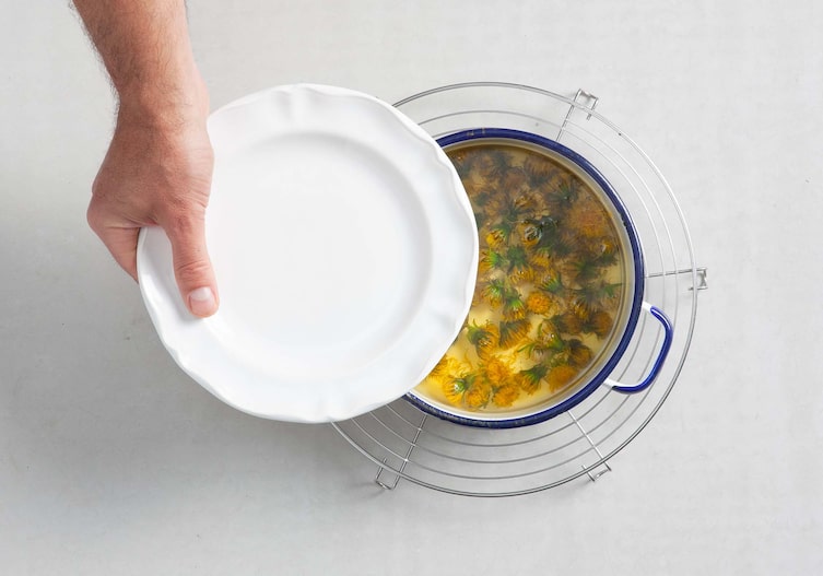 Blüteneis mit heißen Himbeeren, Sirup, Löwenzahnblüten, Teller